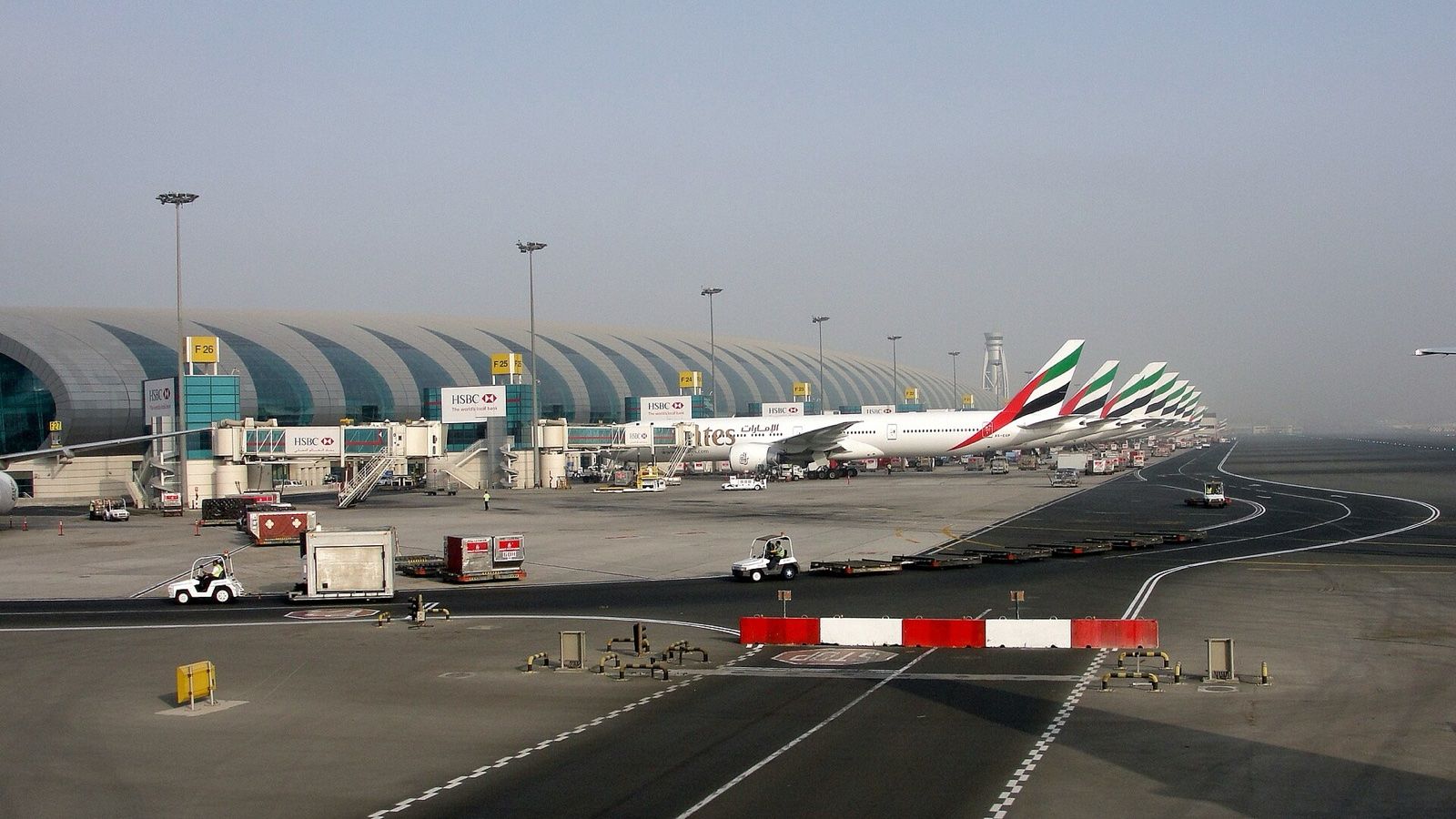 Dubai International Airport Terminal 3 concourse with Emirates aircraft at the gates