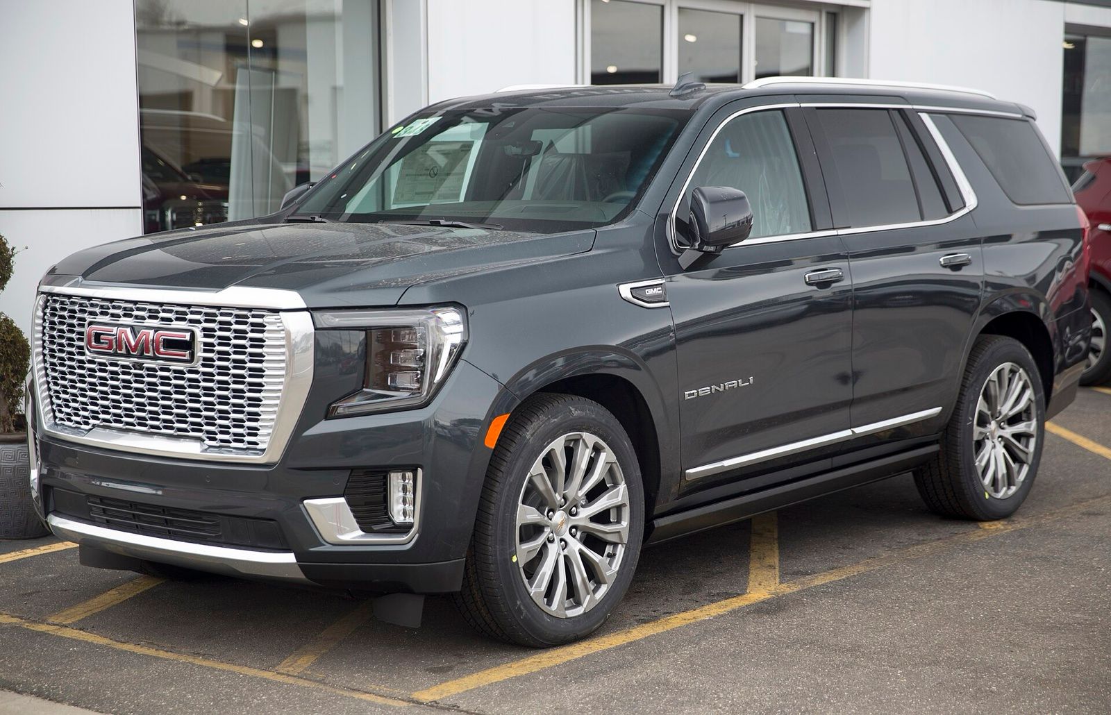 Dark grey GMC Yukon Denali SUV, front three-quarter view