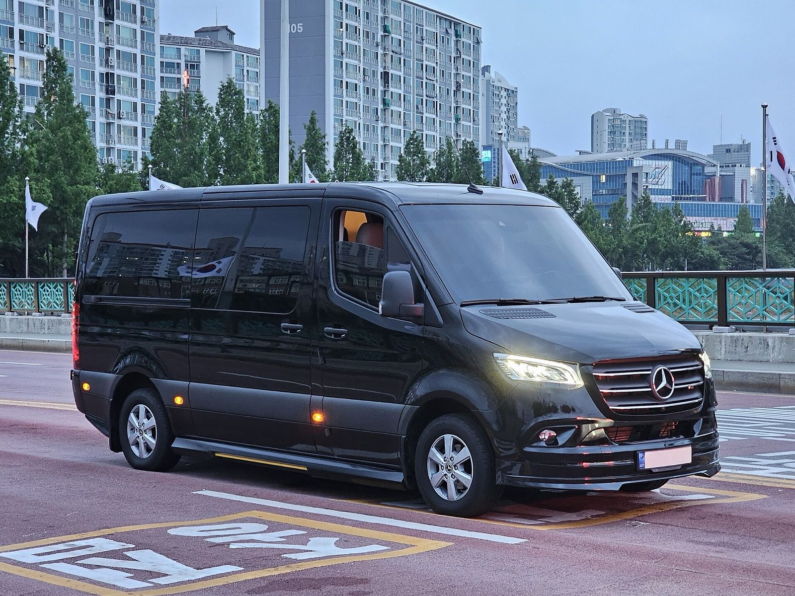Black Mercedes-Benz Sprinter Tourer passenger van on a city road
